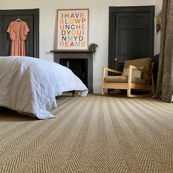 Herringbone sisal carpet in a modern bedroom