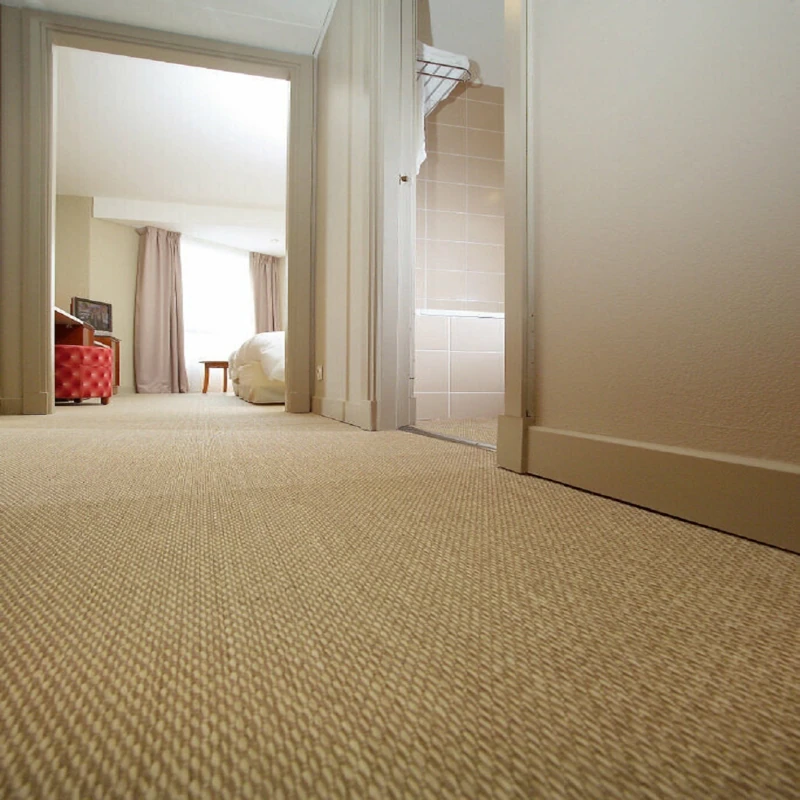 Neutral loop pile carpet in a hotel hallway.