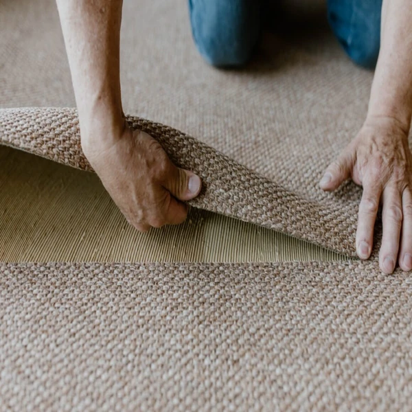 Sandy beige flatweave sisal carpet installation